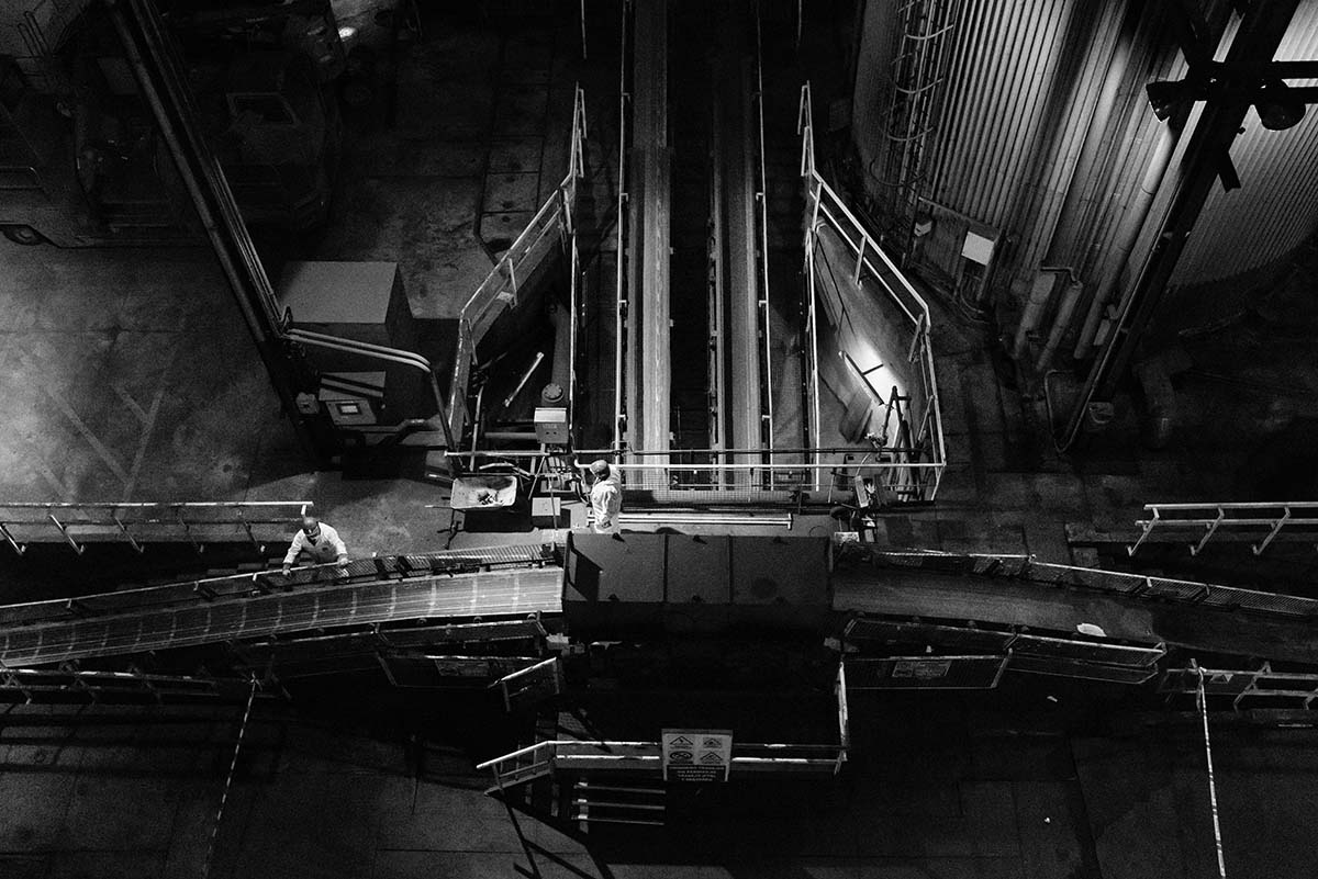 Workers beside the coal conveyor belt in As Pontes