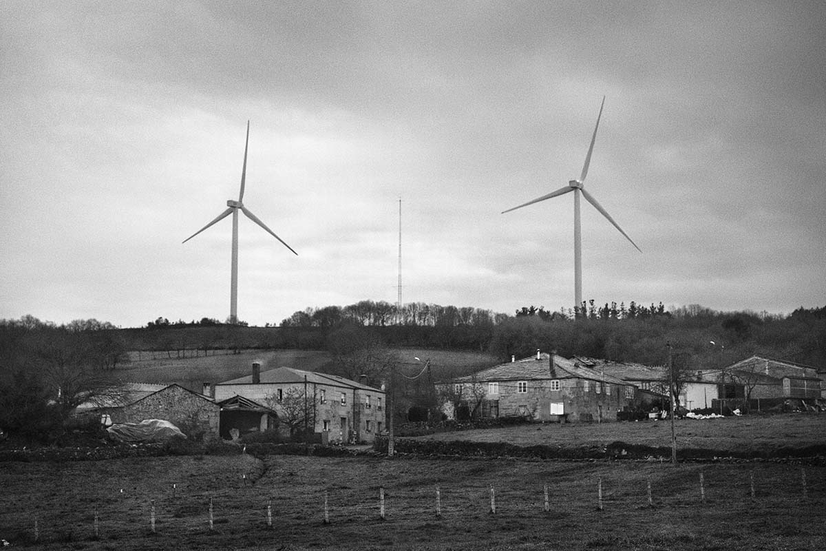 Wind turbines over a meadow in Paradela