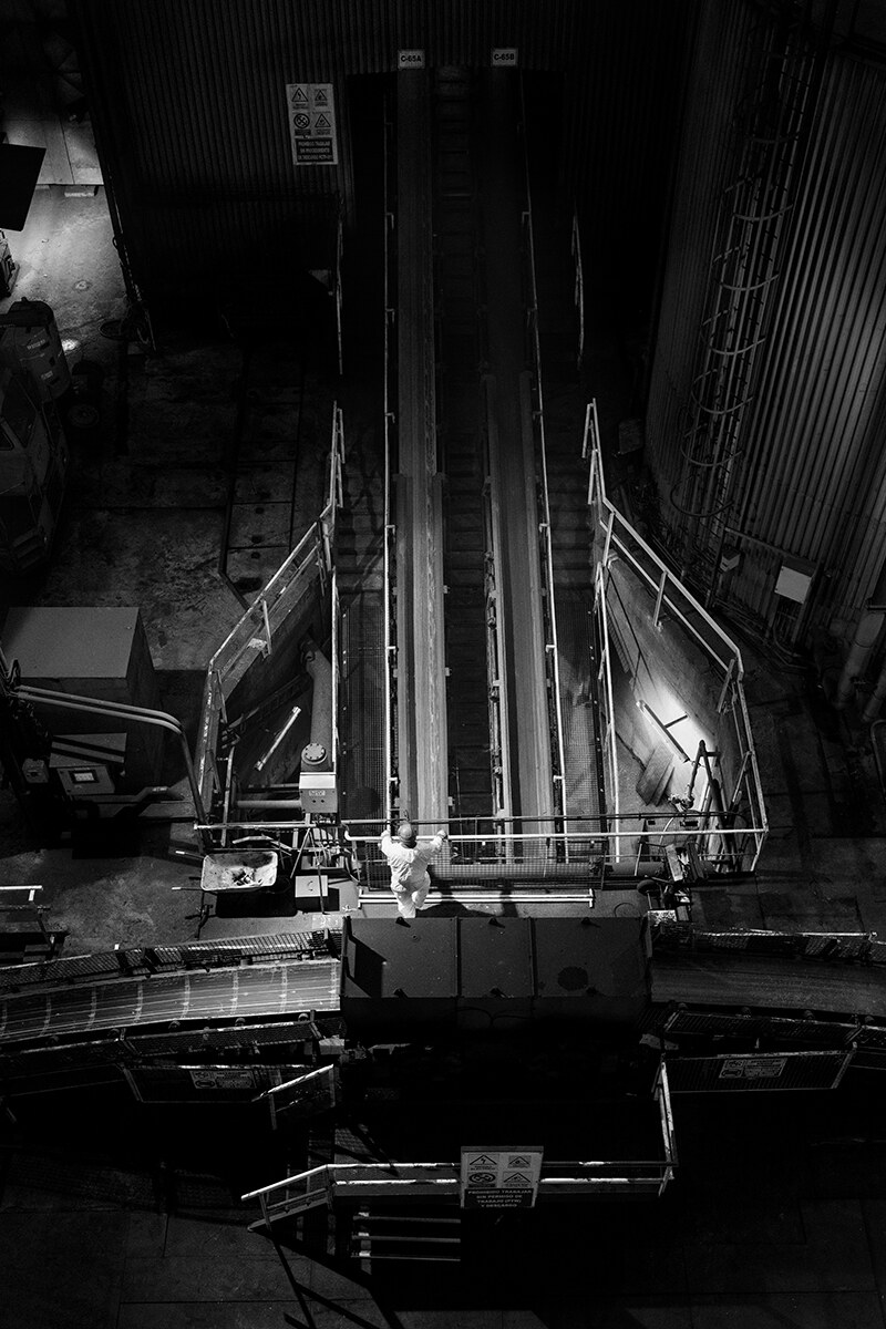 Worker beside the coal conveyor belt at As Pontes